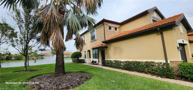 View of property exterior featuring a yard and a water view