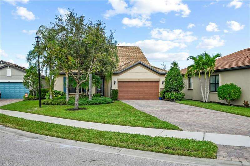 View of front of house with a garage and a front lawn