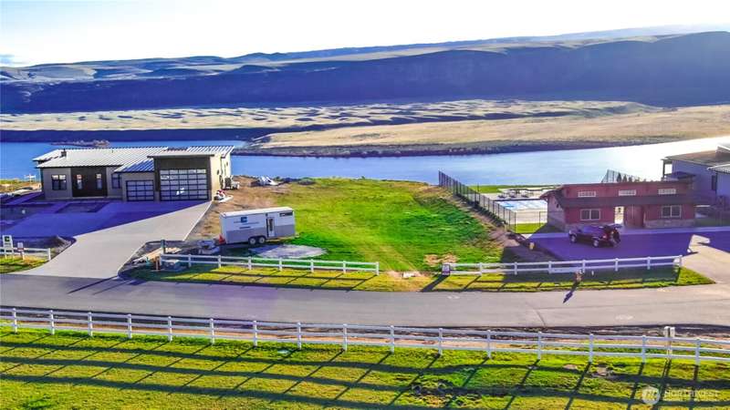 Looking West from above & behind lot. Community Pool & spa next door on right side.
