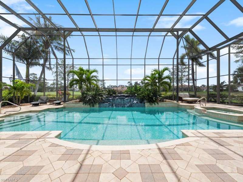 View of pool featuring a pool with connected hot tub, a lanai, and a patio area