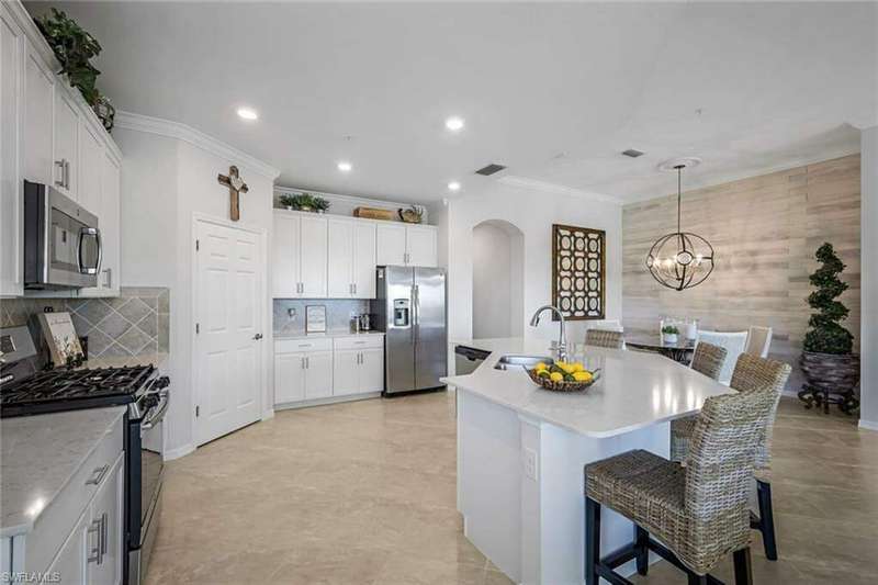 Kitchen with Stainless Appliances, Quartz Countertops, and Walk-In Pantry