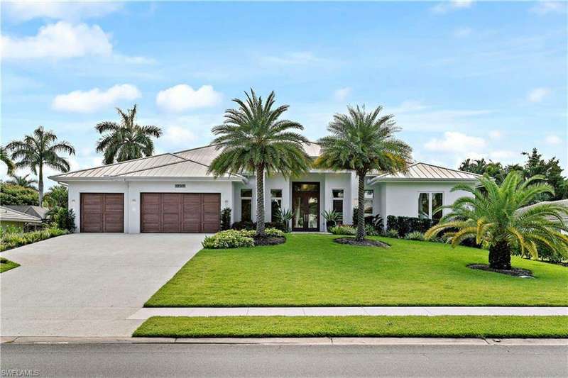 View of front of home featuring a garage and a front lawn