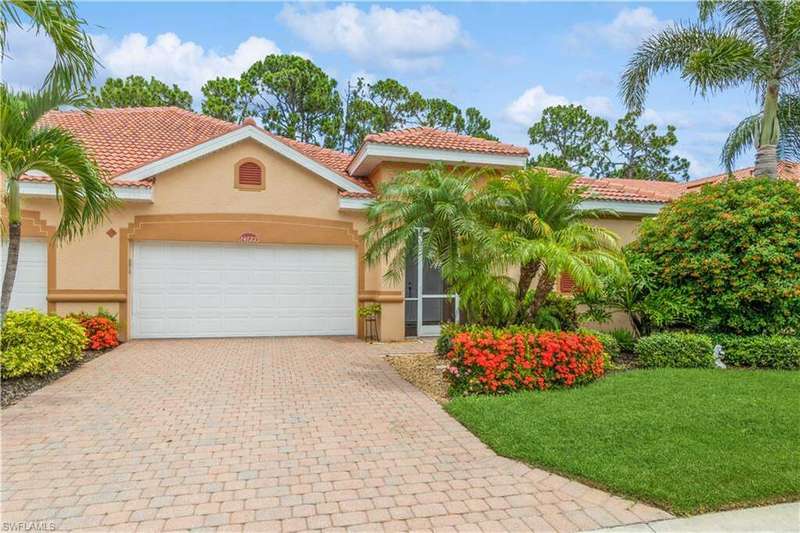 Mediterranean / spanish-style home featuring a front yard and a garage