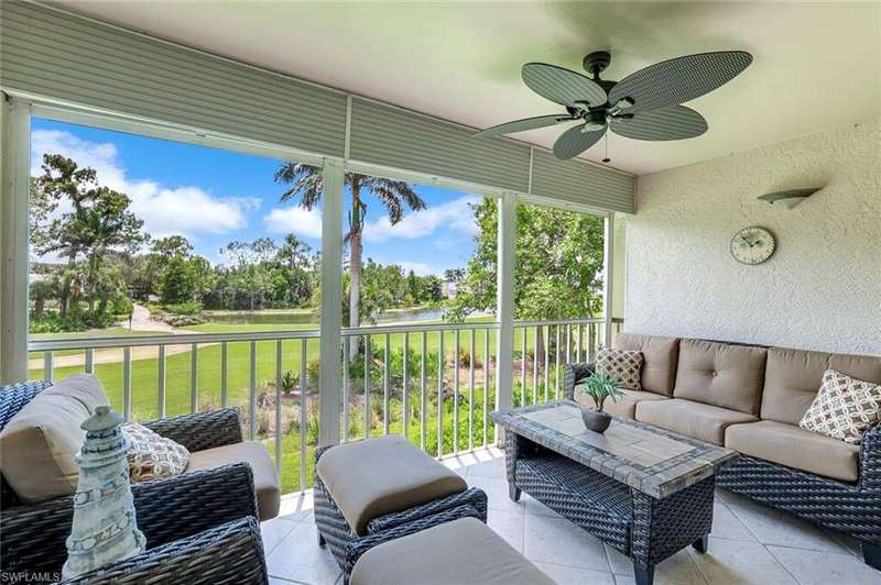 Screened in lanai with manual hurricane shutters, ceiling fan, & a golf course view