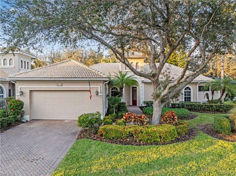 View of front of property featuring a garage and a front yard
