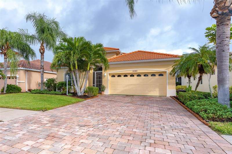Front Exterior with Paver Driveway & Screened Entrance