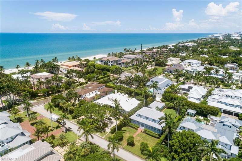 Aerial perspective of suburban area featuring a large body of water