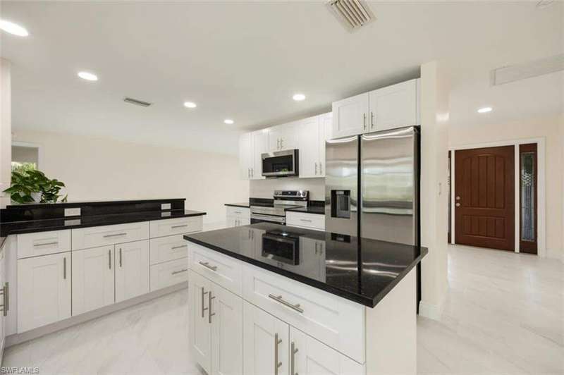 Large sparkling new kitchen overlooking pool and canal