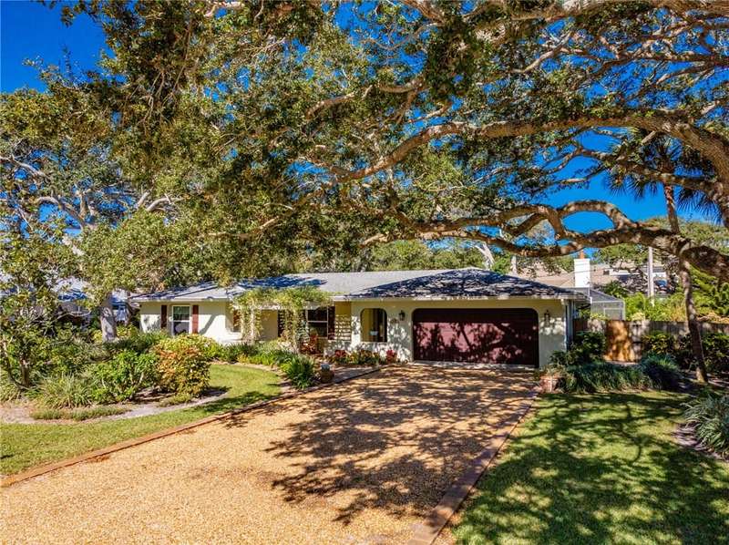 Ranch-style house featuring a chimney, driveway, a