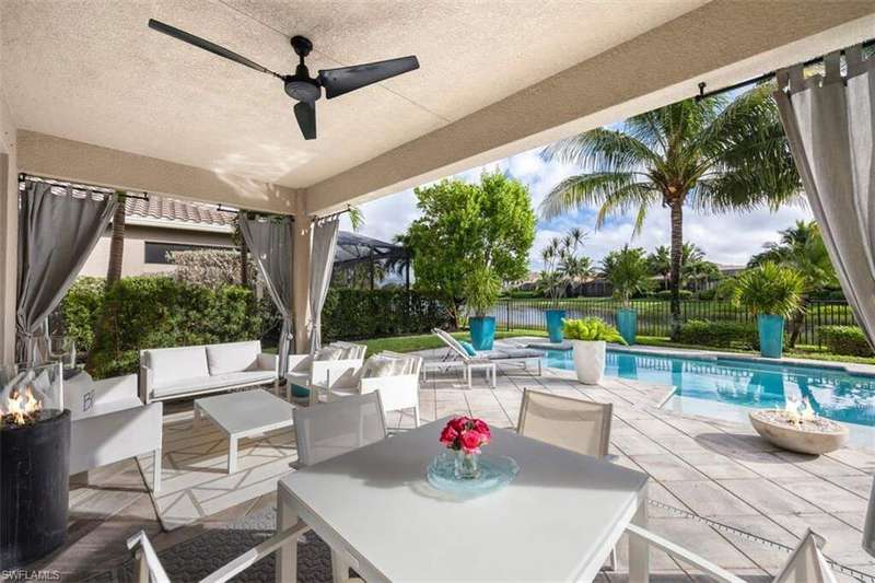 Fenced backyard with a patio, a ceiling fan, an outdoor living space with a fire pit, and outdoor dining area