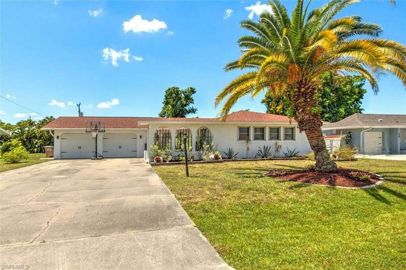 Ranch-style house with a garage and a front yard