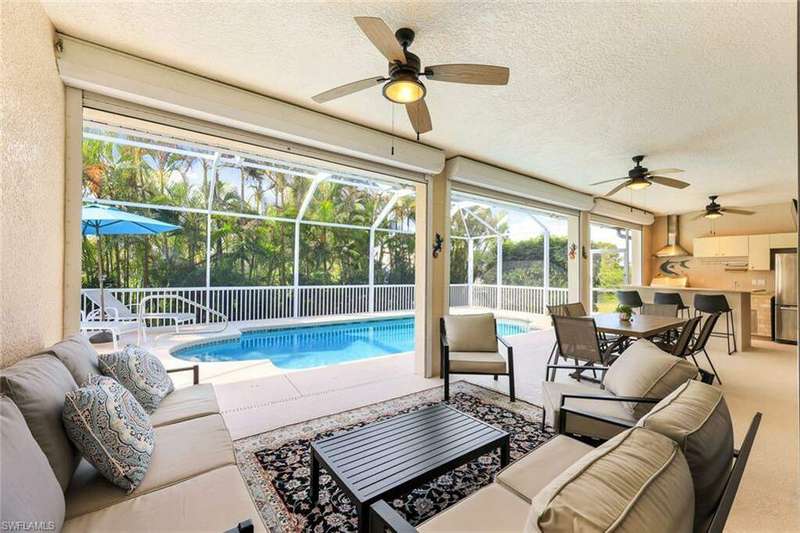 View of swimming pool with ceiling fan