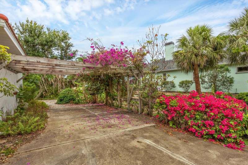 Home is complimented with a large circular driveway, 2 car side entry garage and extended parking area with pergola