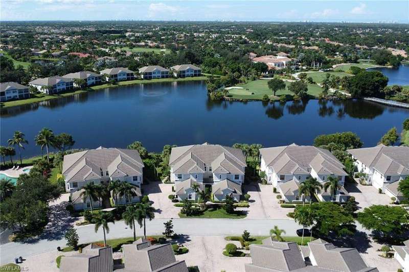 Birds eye view of property with a water view