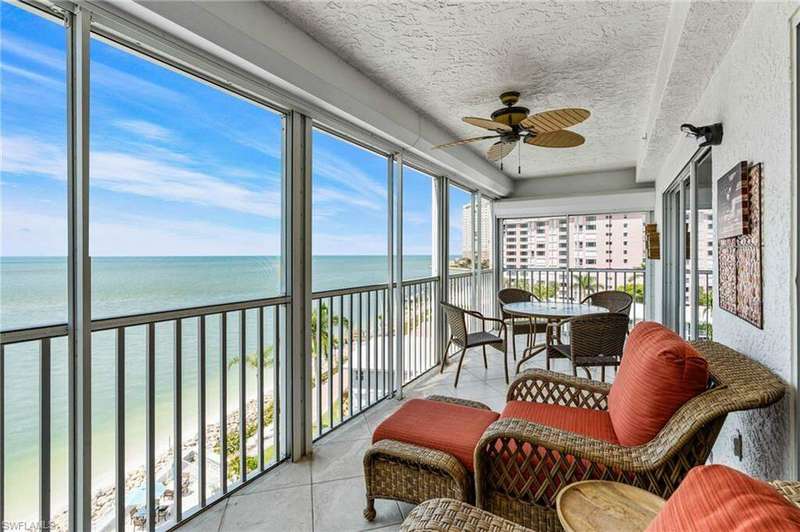 Sunroom featuring ceiling fan and a water view