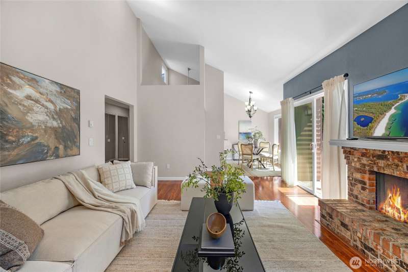 Charming wood burning firplace compliment the open space and soaring vaulted ceilings with plenty of natural light