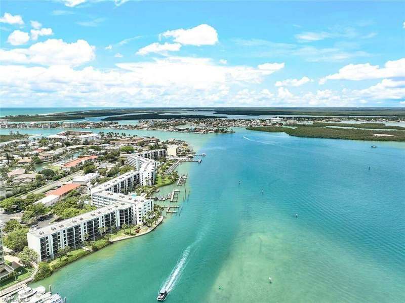 Birds eye view of property with a water view