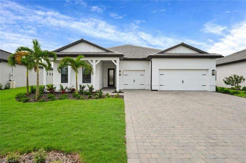 View of front of property with a front yard and a garage