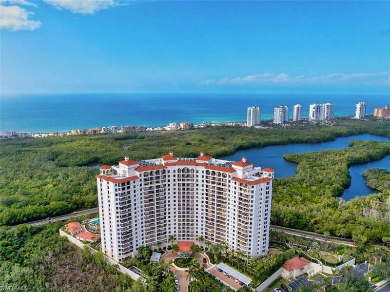 Birds eye view of property with a water view