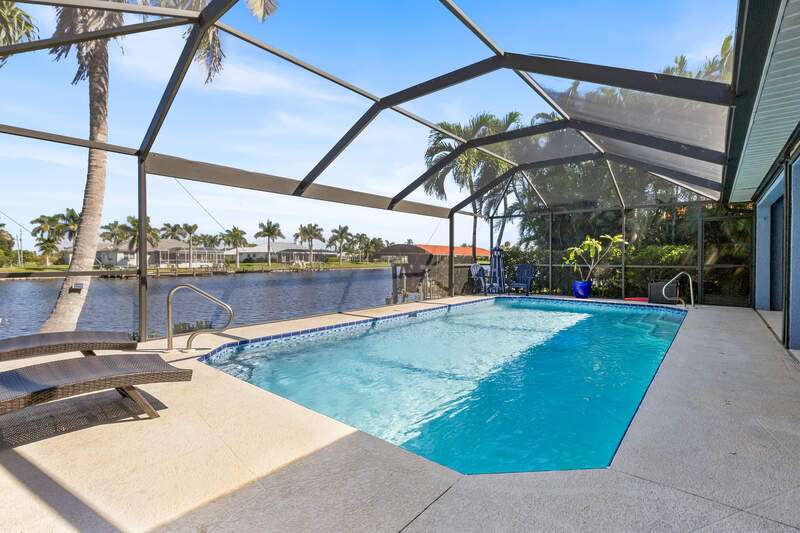 Ranch-style house with stucco siding, an attached garage, concrete driveway, and a front yard