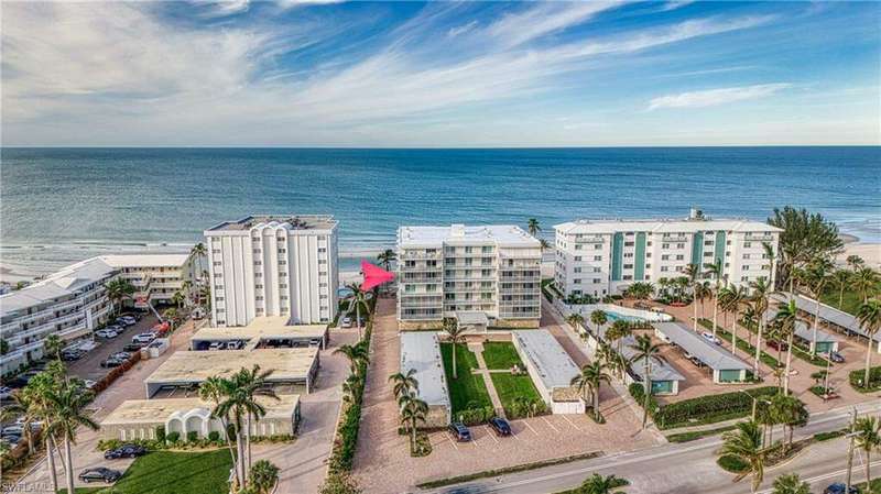 Birds eye view of property with a water view