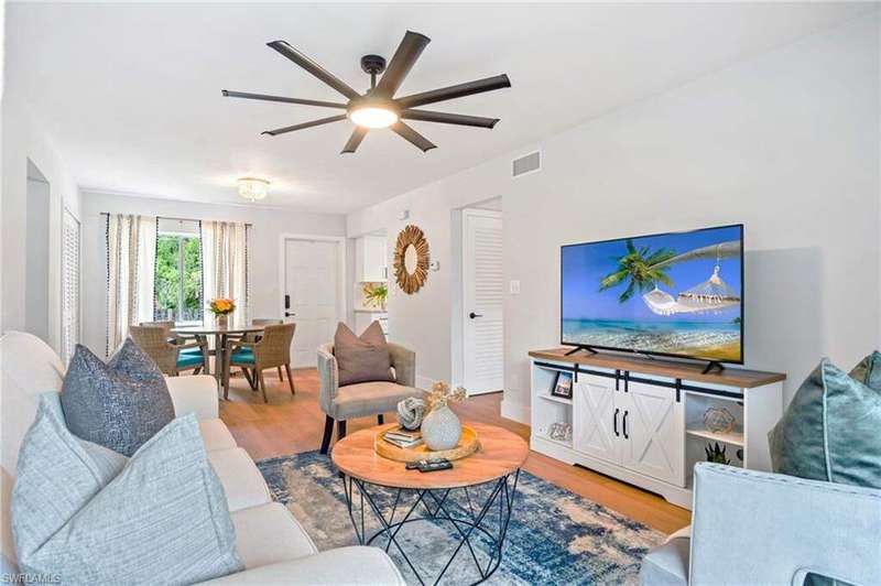 Living room with ceiling fan and light wood finished floors