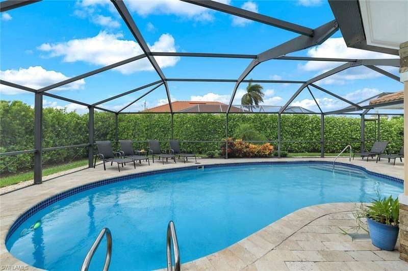 View of swimming pool with a lanai and a patio