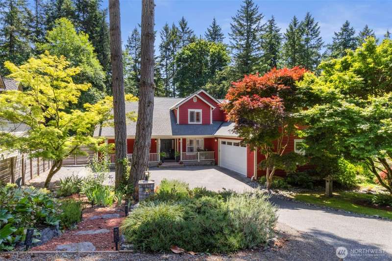 Charming Bainbridge Island home nestled among mature trees, offering privacy and a warm welcome from the moment you arrive.