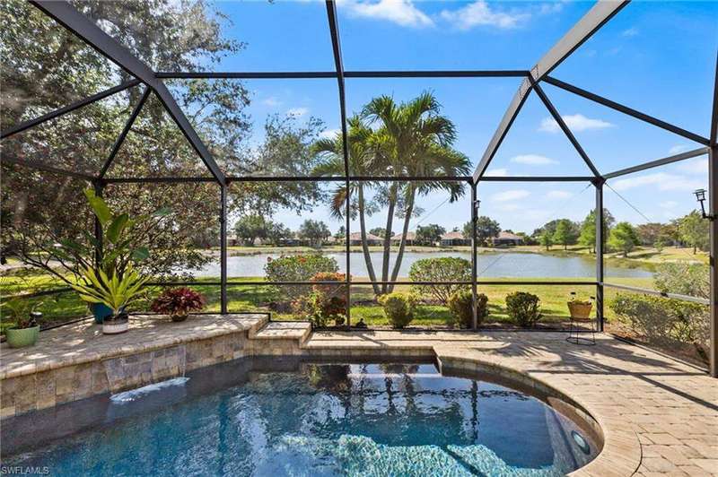 Outdoor pool featuring a water view, a patio area, and a lanai
