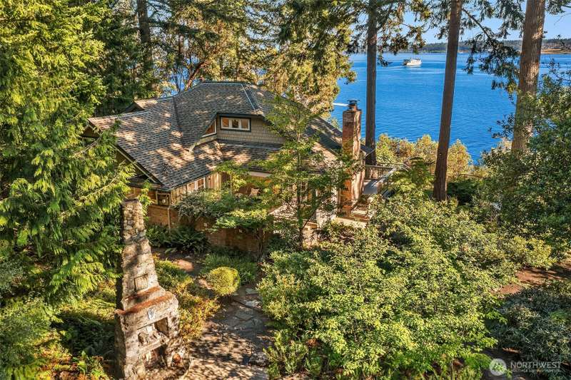The home is nestled amongst tall trees with gorgeous southern views of Puget Sound, Mt. Rainier and Tacoma.