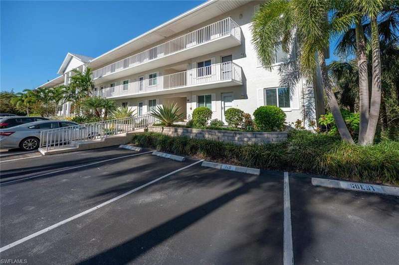 View of property featuring uncovered parking