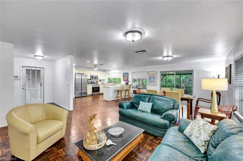 Living room featuring Brazilian walnut floors and open floor plan.