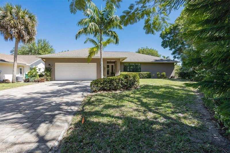 Ranch-style house featuring a front lawn, decorative driveway, a garage, and stucco siding