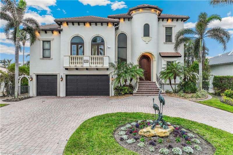 Mediterranean / spanish home featuring a garage