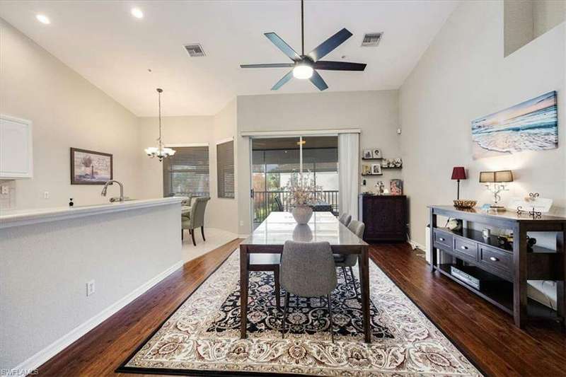 Dining area with Eucalyptus wood-style floors, high vaulted ceiling and ceiling fan opens to the large Lanai.