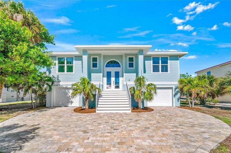 View of front of property featuring a porch and a garage