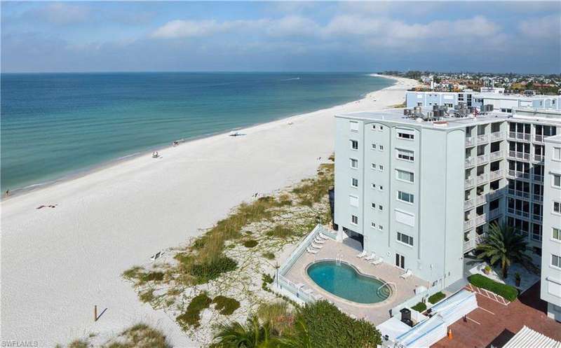 Aerial view of unending shoreline and a pool