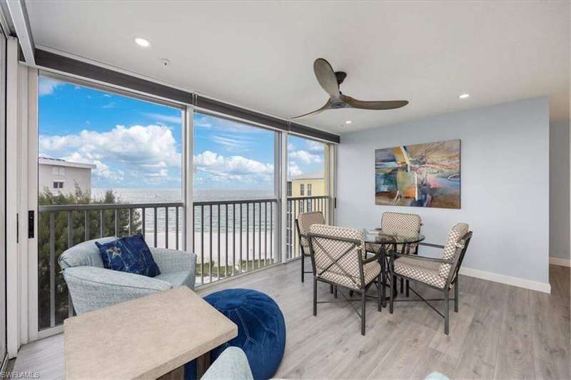 Sunroom featuring a water view