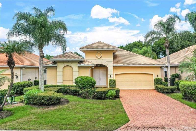 Mediterranean / spanish house with a garage and a front lawn