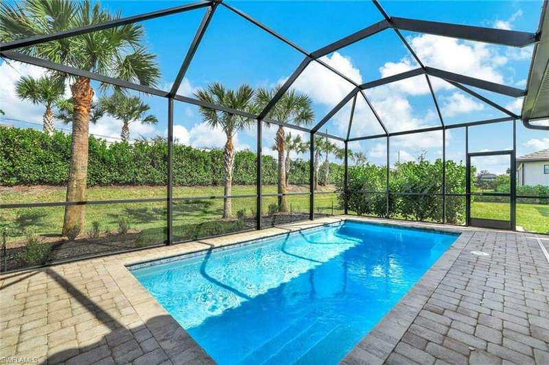 View of swimming pool featuring a lanai, a patio, and a yard