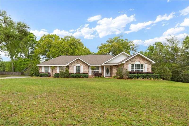 Single story home with a front yard and brick siding