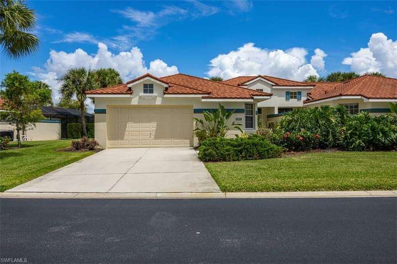 Mediterranean / spanish home with a garage and a front yard