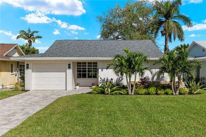 View of front of home featuring a garage and a front lawn