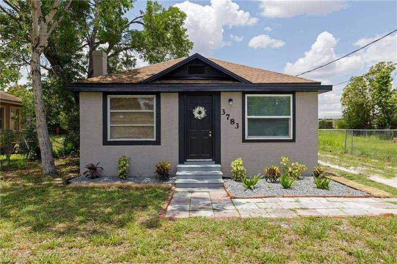 Bungalow-style house with a front lawn