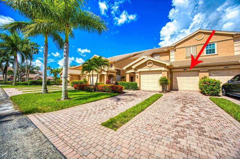 View of front of home featuring a front lawn and a garage