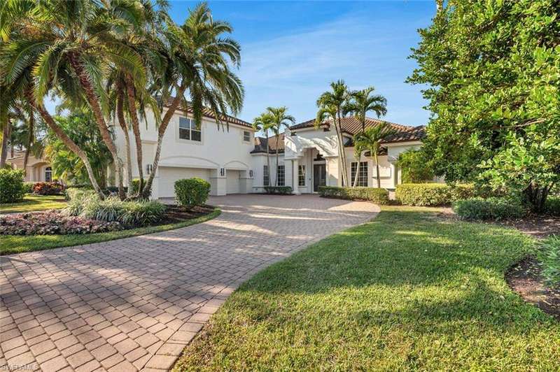 Mediterranean / spanish-style house with a front lawn and a garage