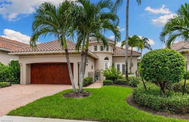 Mediterranean / spanish home with stucco siding, a garage, a tiled roof, driveway, and a front yard