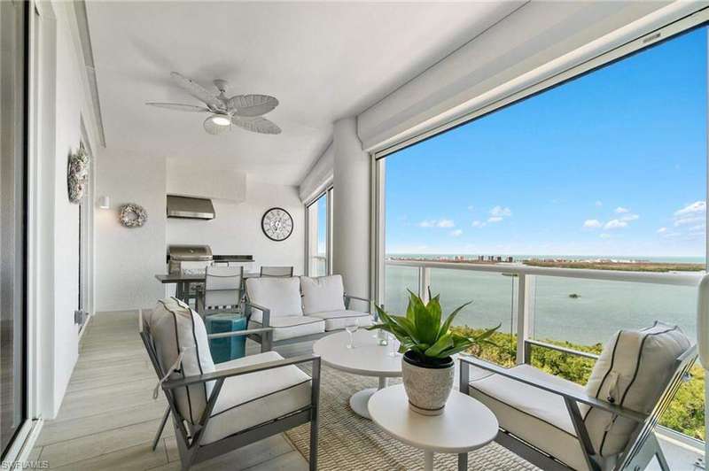 Sunroom with a water view, wood finished floors, and plenty of natural light