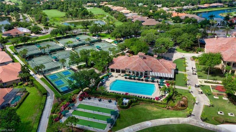 Aerial overview of property's location with a pool area and a nearby body of water