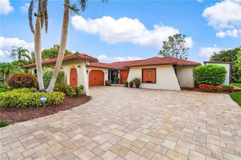 Mediterranean / spanish home with stucco siding, decorative driveway, a tiled roof, and an attached 2 car garage